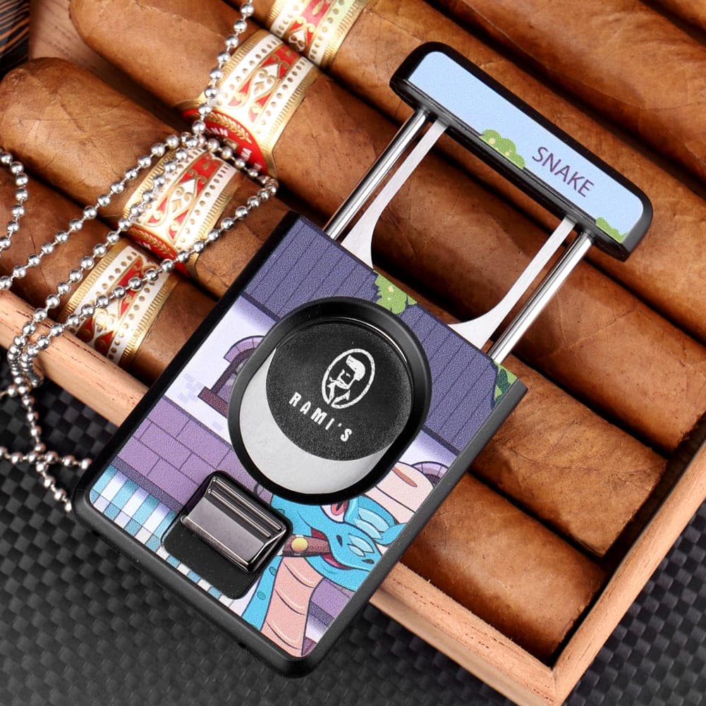 Rami’s Year of the Snake Cigar Cutter open and resting on an open wooden cigar box