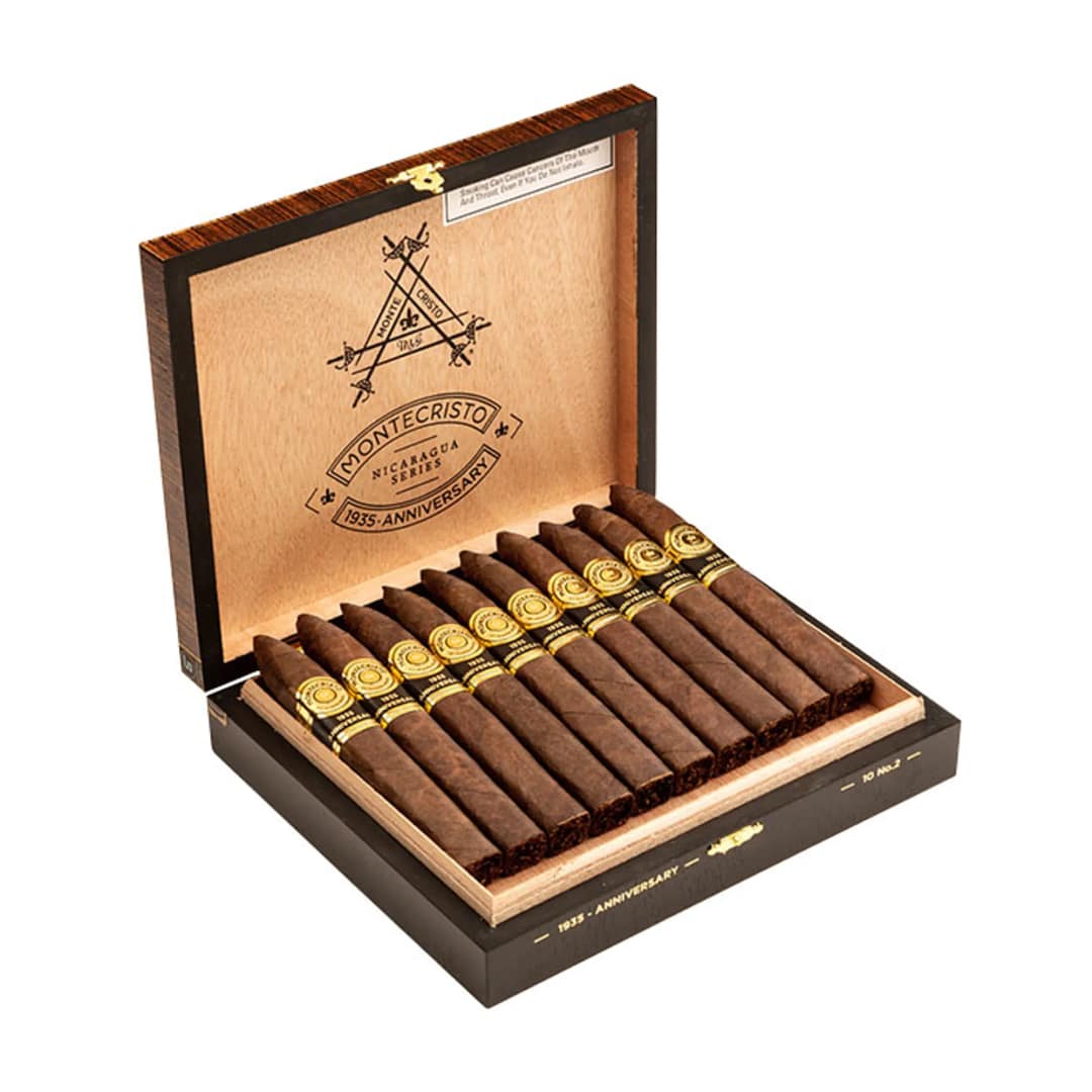 Open box of Montecristo 1935 Anniversary Nicaragua Torpedo cigars with dark, oily Habano wrappers and sleek, bold bands.