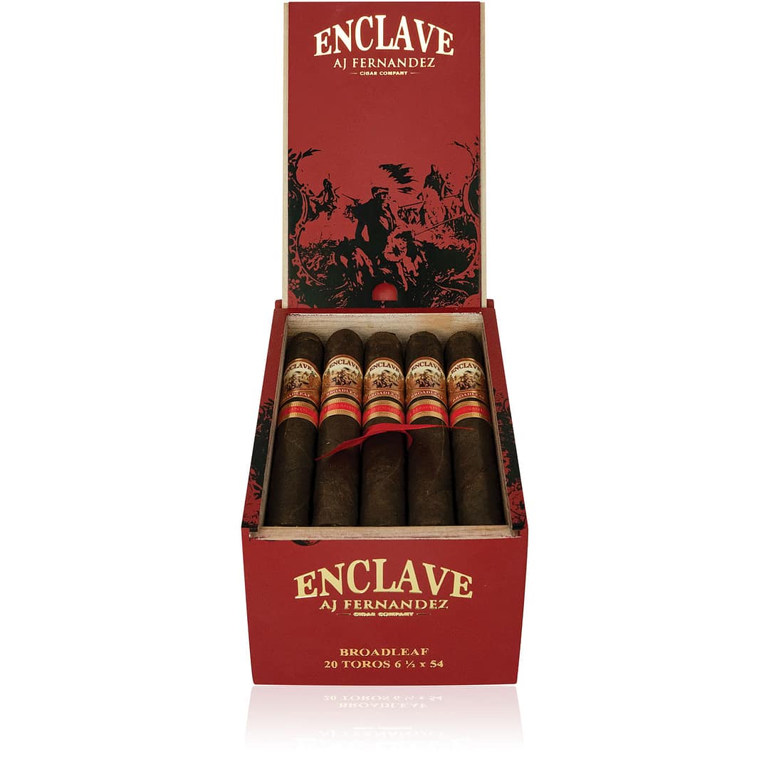 An open box of Enclave Broadleaf cigars, featuring dark, oily Connecticut Broadleaf wrappers and neatly arranged cigars, showcasing their bold, full-bodied flavor profile with notes of dark chocolate, coffee, and pepper.