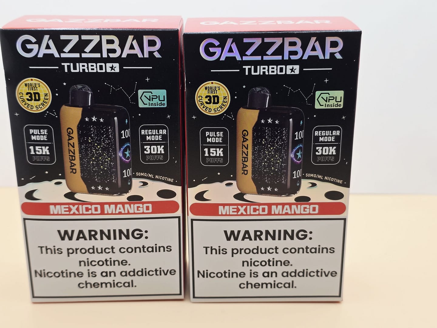2 Pack Gazzbar Disposable Vape Mexico Mango flavor with 30,000 puffs, 28ml e-liquid, dual mesh coil, 800mAh quick charge battery, and 3D curved screen.