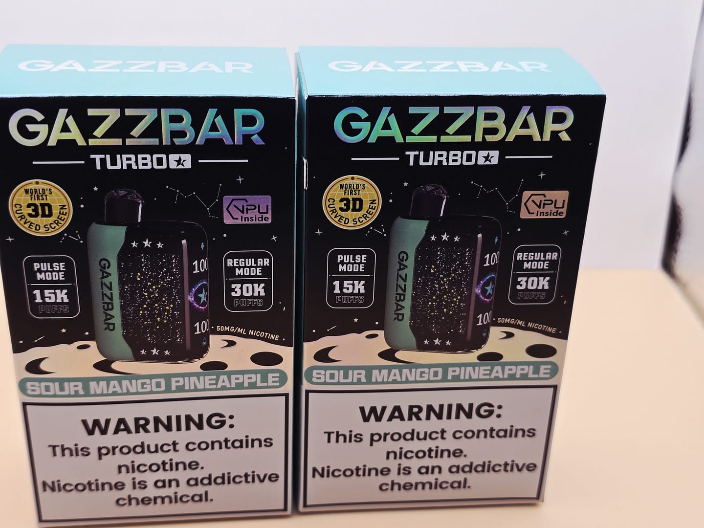 2 Pack Gazzbar Disposable Vape Sour Mango Pineapple flavor with 30,000 puffs, 28ml e-liquid, dual mesh coil, quick charge battery, and 3D curved screen