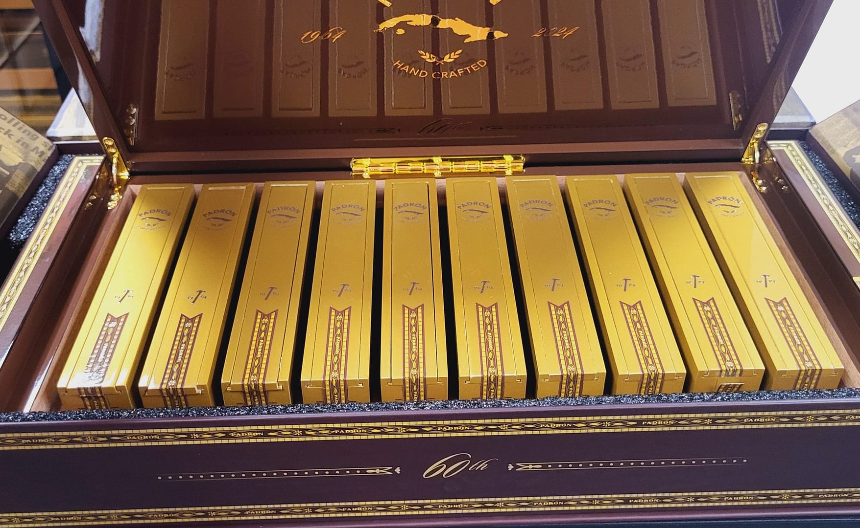 Open box of Padrón 1964 Anniversary 60th Maduro Limited Edition cigars with dark wrappers and signature bands