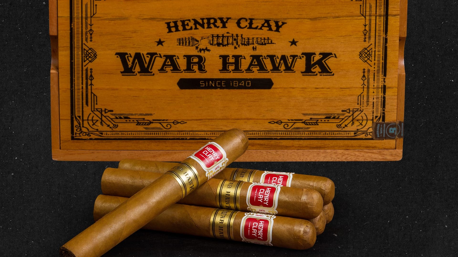 Five Henry Clay War Hawk cigars with closed box in background