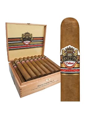 Ashton Cabinet Selection cigar featuring a smooth, golden Connecticut Shade wrapper with a classic white and gold band, resting elegantly on a wooden surface."