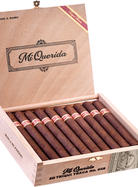 Open box of Mi Querida Triqui Traca cigars with dark, rustic wrappers and elegant banding