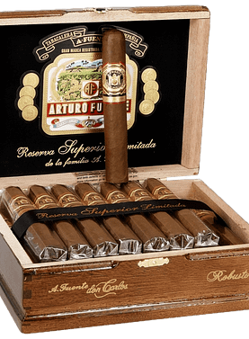Open box of Arturo Fuente Don Carlos cigars with dark Cameroon wrappers and red-and-gold bands displayed in a cedar-lined presentation.