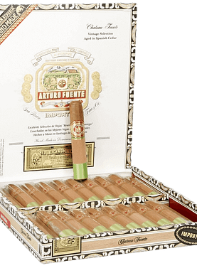 Open box of Arturo Fuente Château Fuente cigars with cedar sleeves and signature white bands, displayed in a classic wooden box.