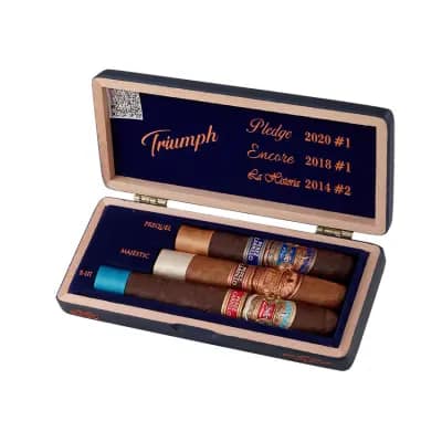 E.P. Carrillo Trilogy Triumph Sampler featuring three premium cigars from La Historia, E.P. Carrillo Core, and Pledge blends, each with distinct wrappers and bands, showcasing the variety and craftsmanship of E.P. Carrillo cigars