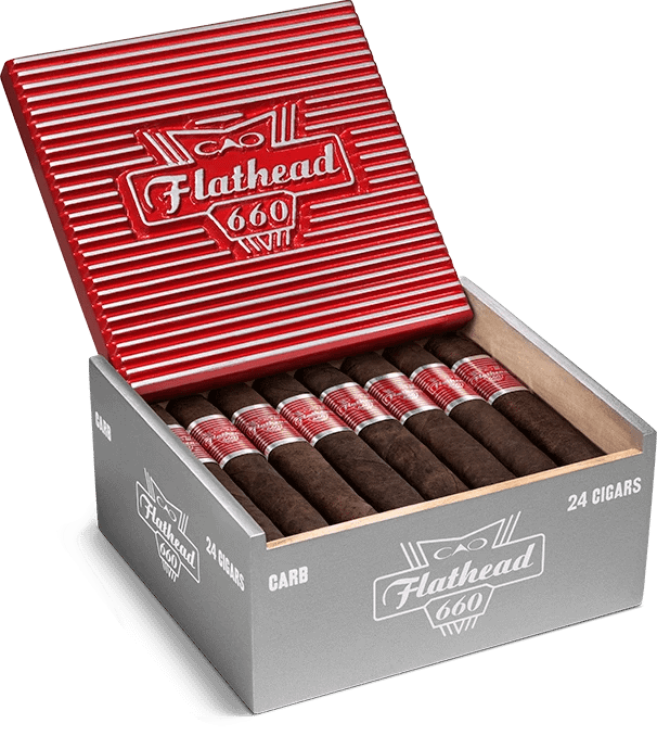 Open box of CAO Flathead cigars with dark, box-pressed wrappers and retro automotive-themed packaging.