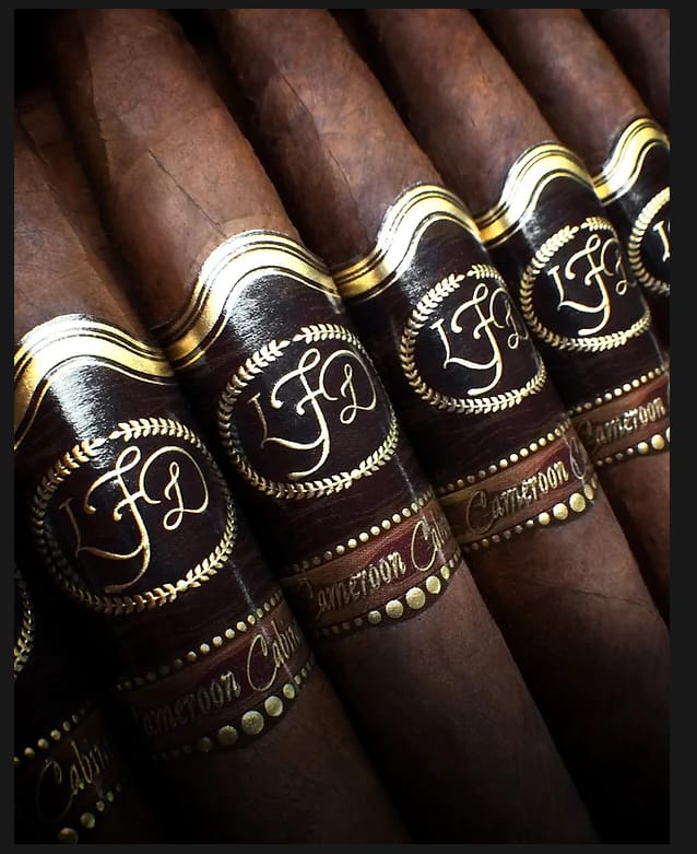 La Flor Dominicana Cameroon Cabinet cigar with a silky, reddish-brown wrapper and elegant, traditional band.