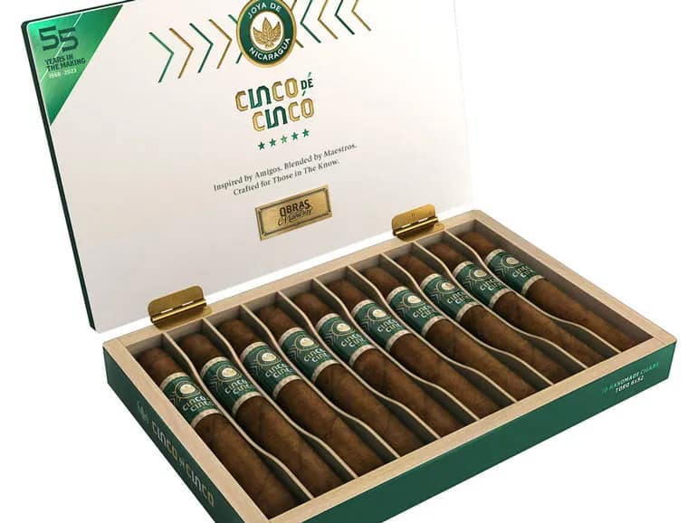 Open box of Joya de Nicaragua Cinco de Cinco cigars, displaying their rich, dark wrappers and elegant presentation.