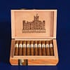 Open box of Highclere Castle cigars, featuring golden-brown wrappers neatly arranged inside an elegant, crest-embossed box