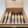 Open box of La Mission du L'Atelier 1959 cigars with dark San Andrés wrappers and elegant red-and-gold bands.