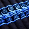 La Flor Dominicana La Nox cigar with a dark, oily wrapper and a striking deep blue and black band featuring a moonlit night design