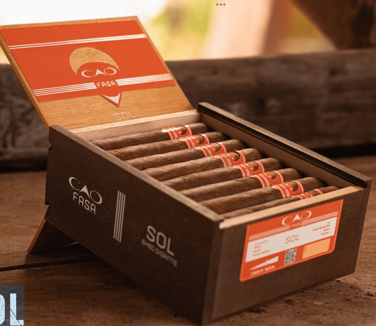 Open box of CAO Fuma Sol cigars with vibrant Ecuadorian Sumatra wrappers and sleek, vibrant banding.