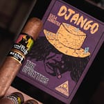 Single The Upsetters cigar resting on a closed box with colorful, vibrant artwork highlighting its unique Jamaican-inspired style