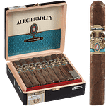 Single Alec Bradley Prensado cigar with dark oily wrapper in front of an open box showing multiple cigars.