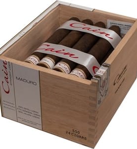 Open box of Cain Maduro cigars featuring dark, oily wrappers and bold branding