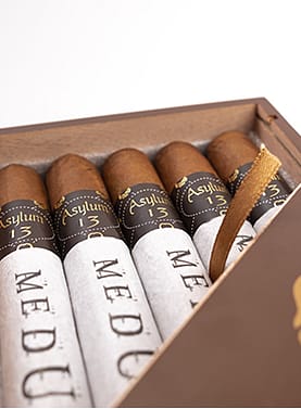 Asylum 13 Medulla Oblongata cigar with a dark, rich wrapper and distinctive band