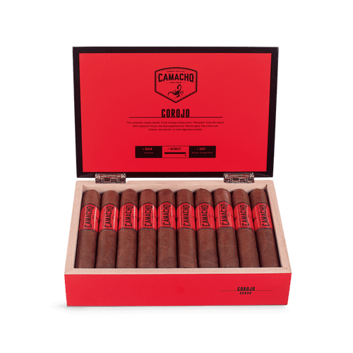 Open box of Camacho Corojo cigars featuring bold red bands and rich brown wrappers