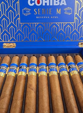 Open box of Cohiba Serie M Reserva Azul premium cigars with rich blue accents