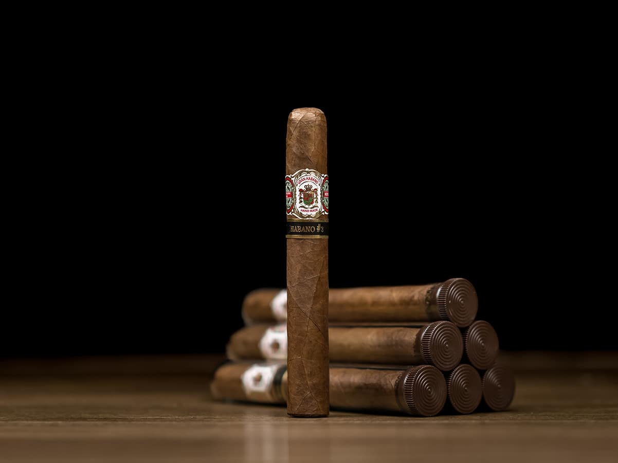 Single Gran Habano No. 3 Habano cigar with five cigars in the background