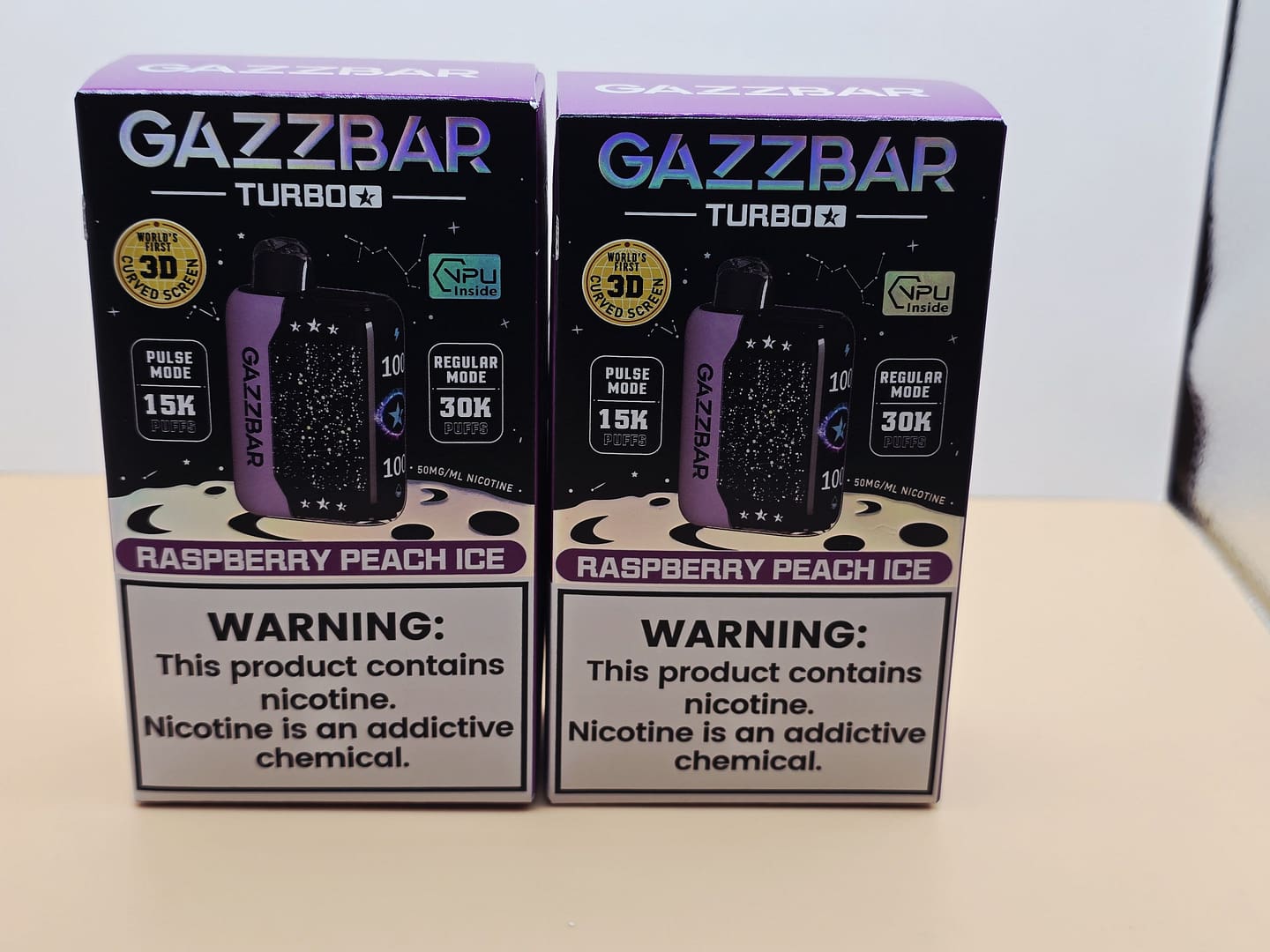 2 Pack Gazzbar Disposable Vape Raspberry Peach Ice flavor with 30,000 puffs, dual mesh coil, and quick charge battery.