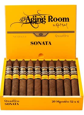 Open box of Aging Room Quattro Sonata Maestro cigars with reddish-brown wrappers and gold-trimmed bands