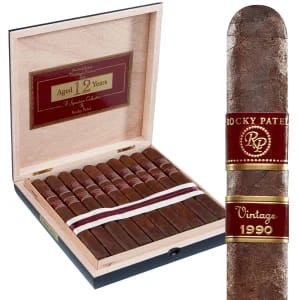 Open box of Rocky Patel 1990 Broadleaf cigars, featuring the dark, rich broadleaf wrappers and neat arrangement inside
