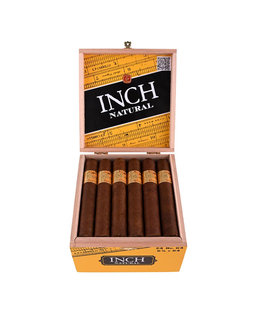 Open box of Inch Natural cigars with golden-brown wrappers and bold bands, neatly arranged in a wooden box.